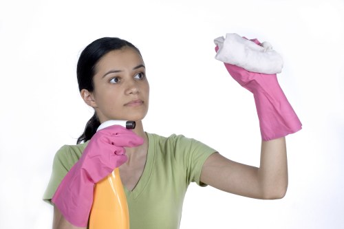 Professional cleaner working in a Finchley kitchen and bathroom